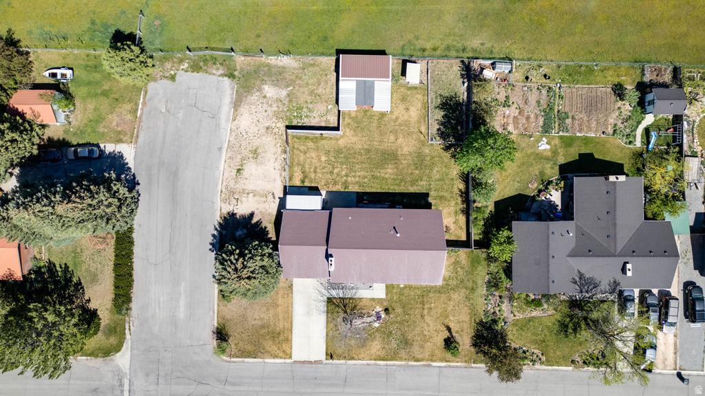 Property featuring a metal roof, an expansive grassy yard, and a concrete driveway
