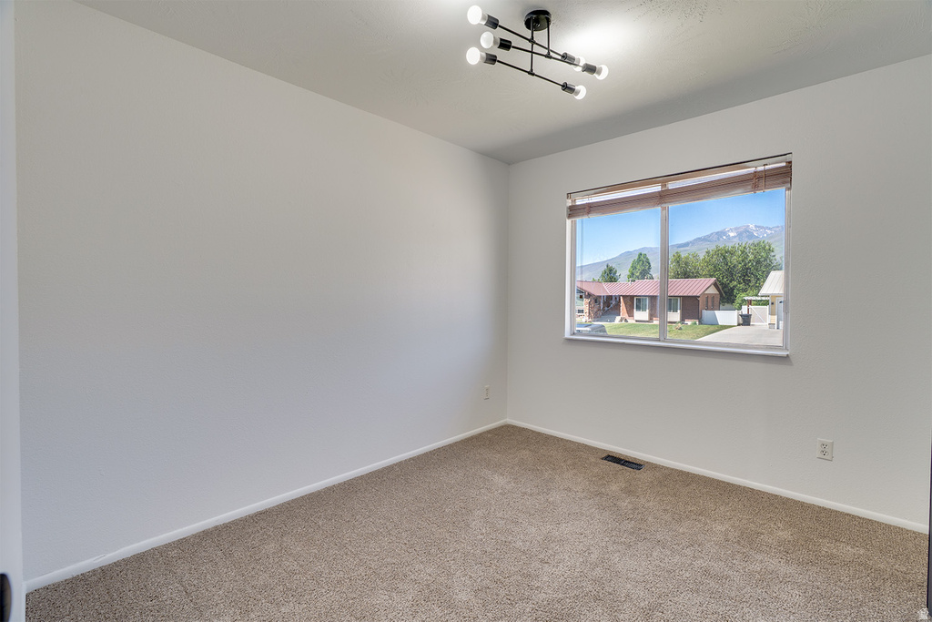 Room with neutral-toned carpet flooring and white walls