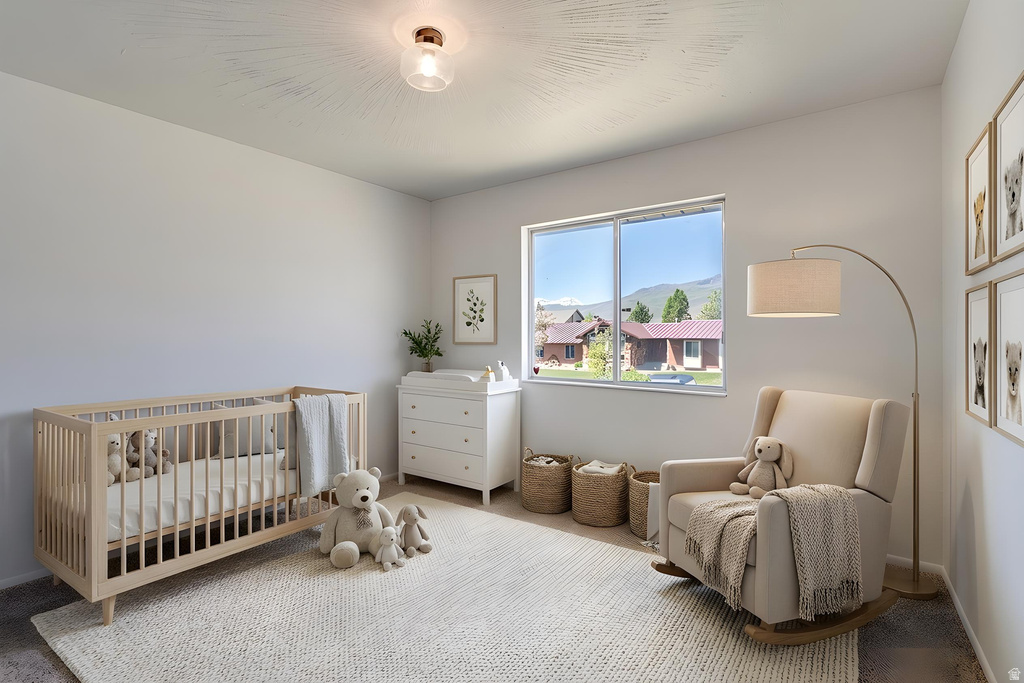 Bright room featuring neutral wall tones, a large window, a ceiling light fixture, and textured carpeting