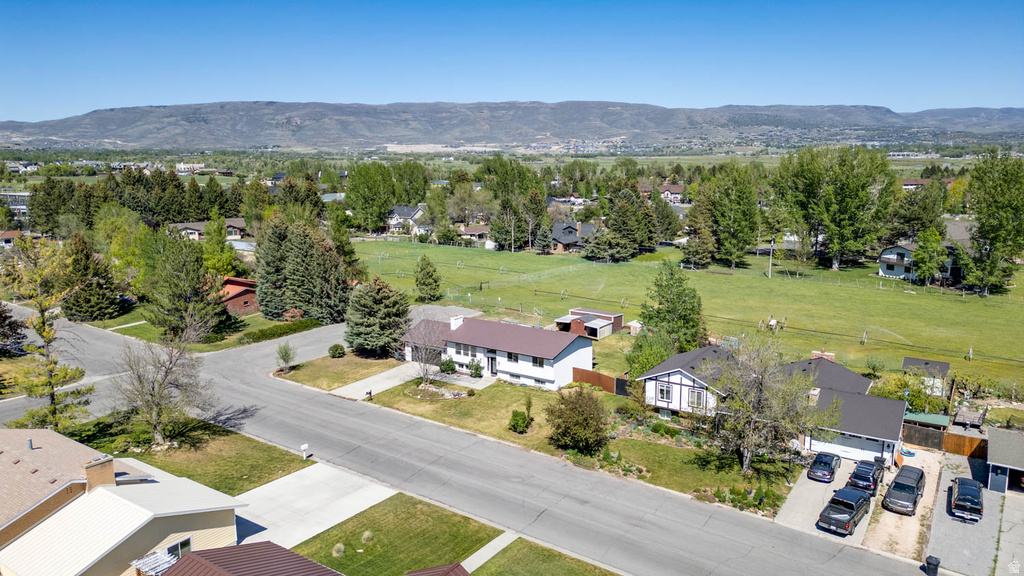 Neighborhood featuring mature trees and mountain backdrop
