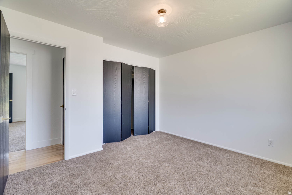 Spacious room with plush carpet flooring and clean white walls