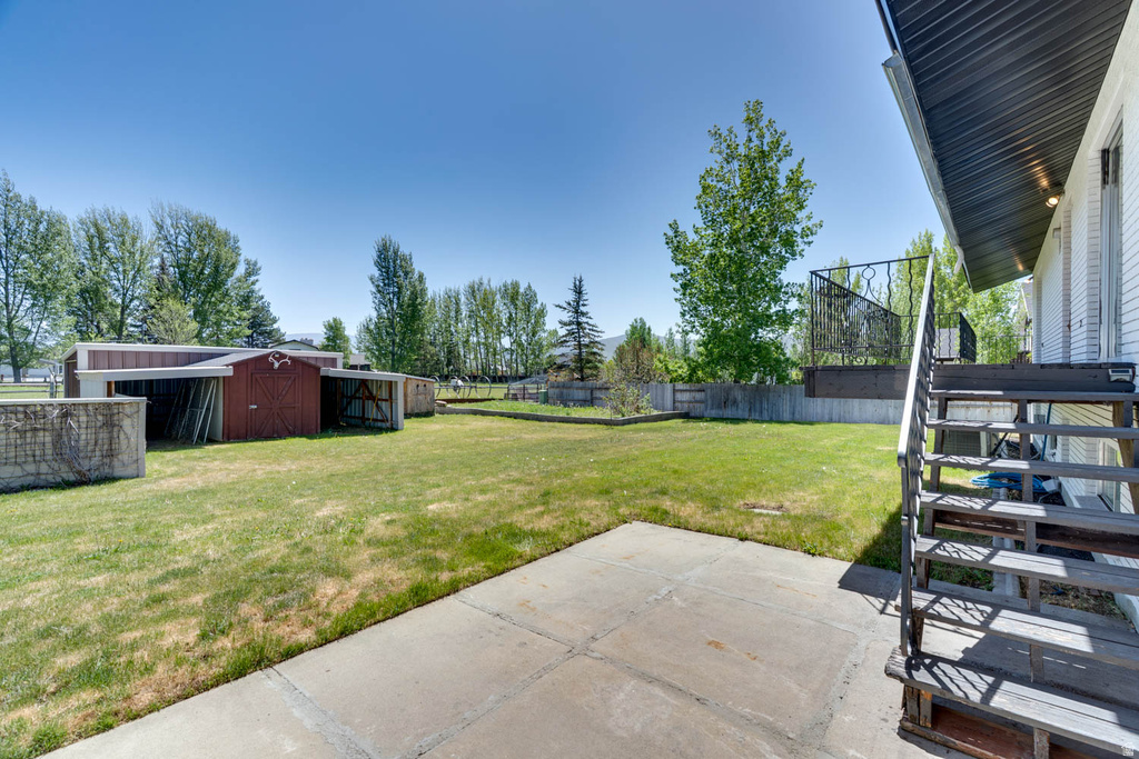 Expansive backyard with a concrete patio and direct access to the main residence