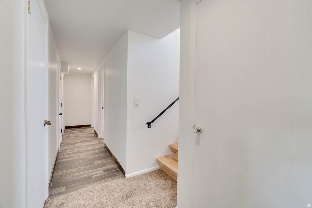Hallway with wood-finish tile flooring and recessed lighting