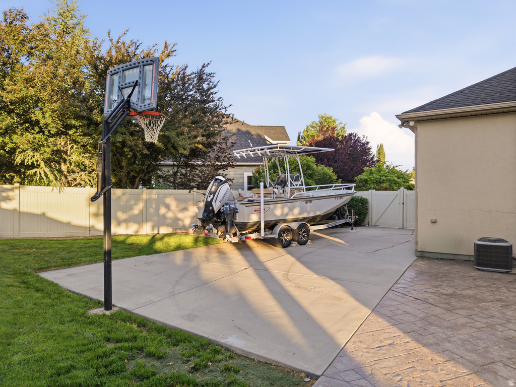 Outdoor recreational area featuring a basketball hoop with a clear backboard