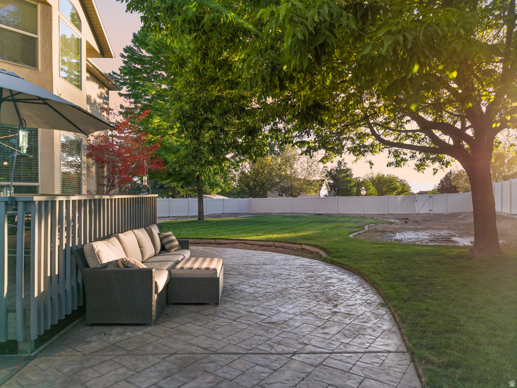 Stamped concrete patio featuring a curved design and a low retaining wall
