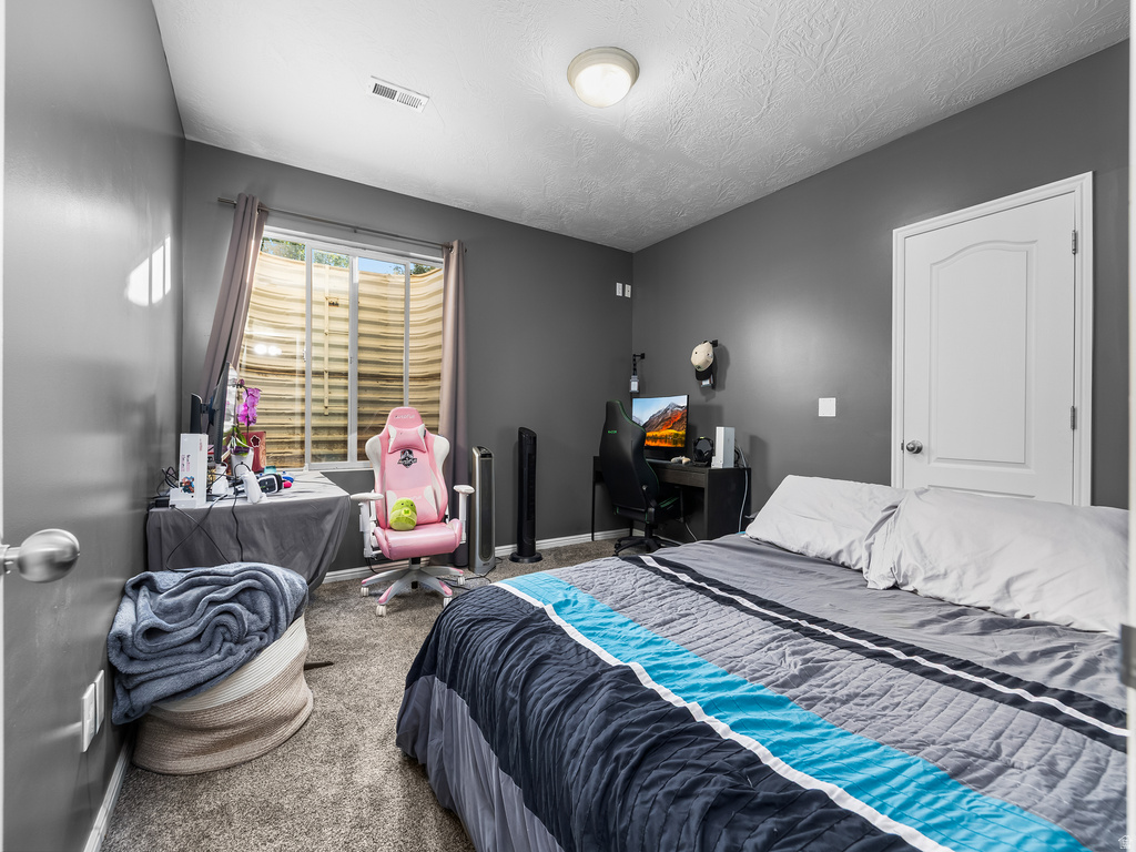 Carpeted room featuring a white interior door with paneling, a recessed window, and neutral gray wall paint