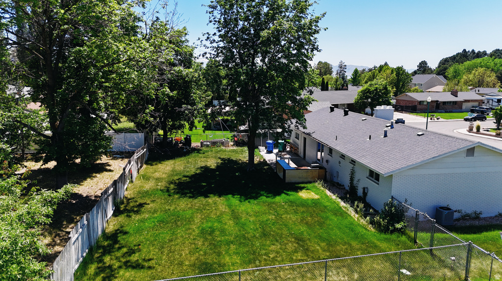 Expansive grassy yard with mature trees