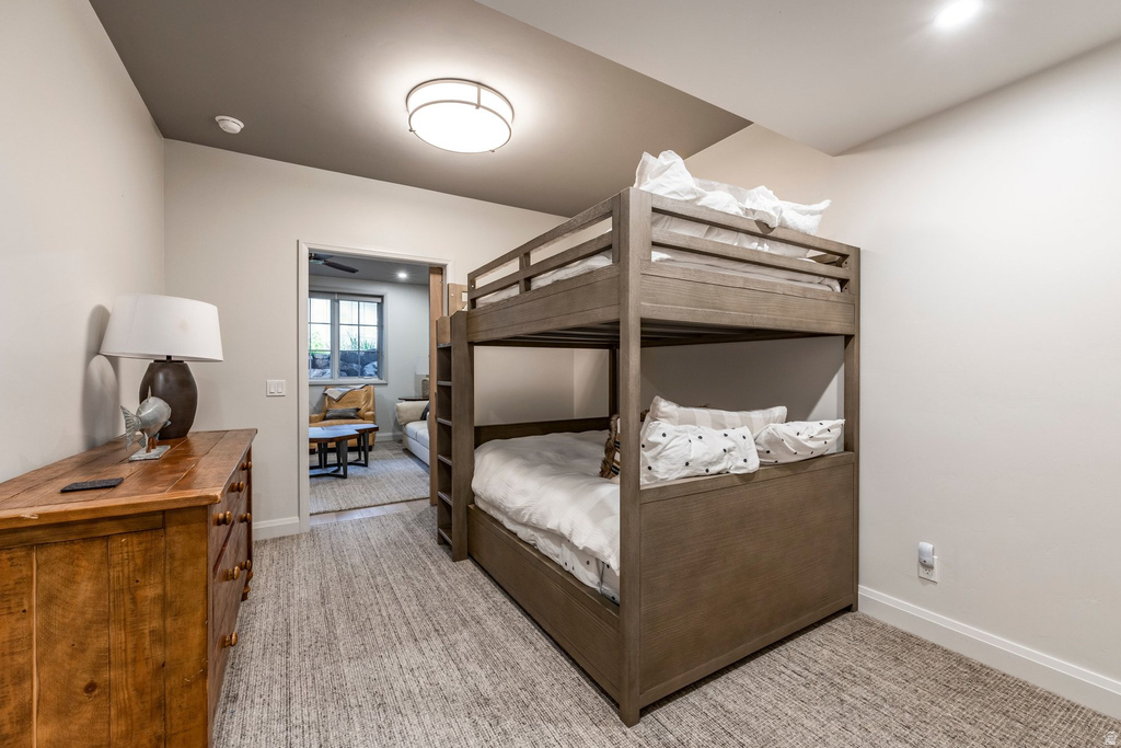 Carpeted bedroom featuring a wooden bunk bed, a flush-mount ceiling light, and recessed lighting