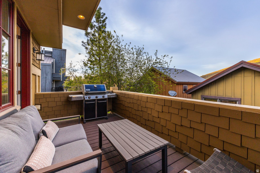 Private outdoor deck featuring wood-finish decking and cedar shingle siding