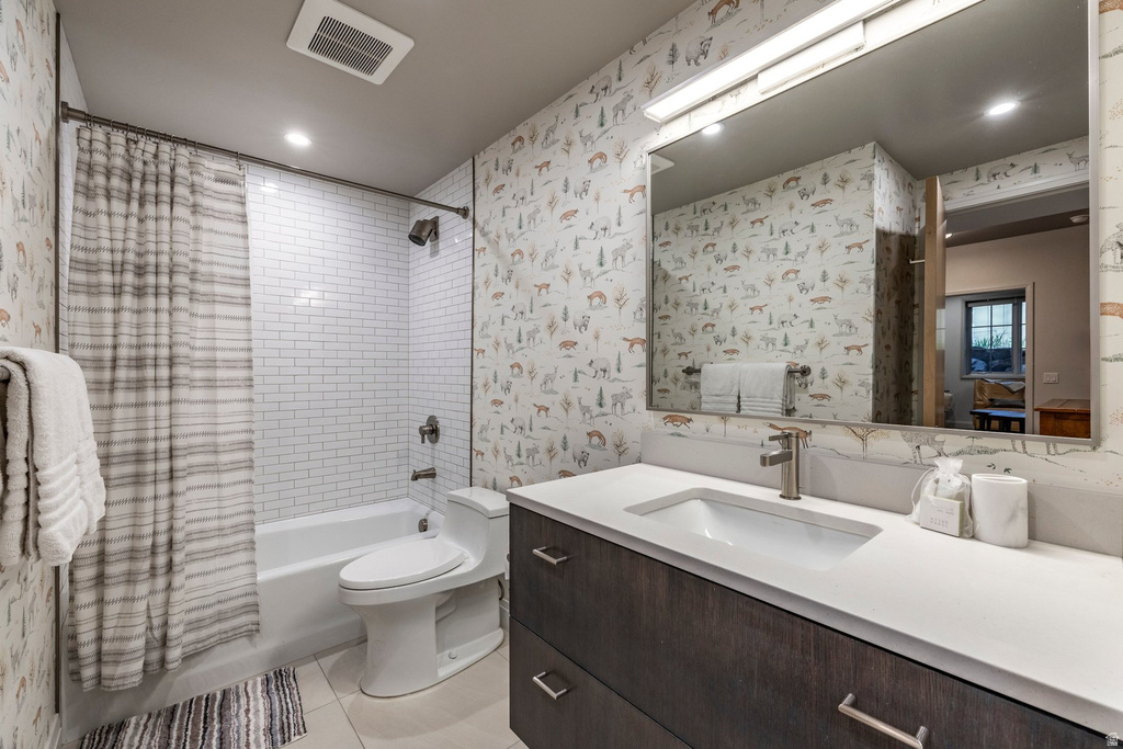 Bathroom featuring a vanity with dark wood-finish cabinetry, a white countertop, and an integrated rectangular sink