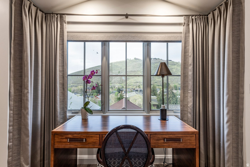 Windowed alcove featuring a three-panel window with grid accents, a fabric roller shade, and ceiling-mounted directional lighting