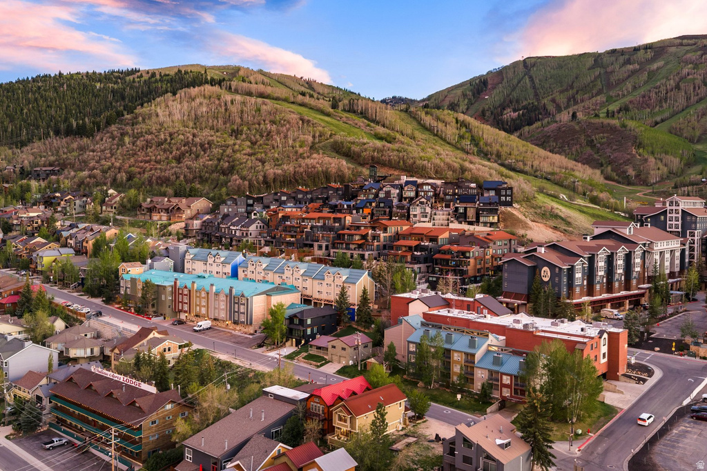 Expansive mountain landscape featuring a community with diverse architectural styles, multi-story buildings, and visible roadways