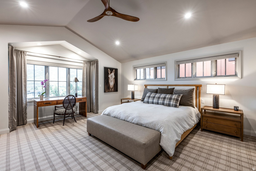 Spacious sleeping area with vaulted ceilings and recessed lighting