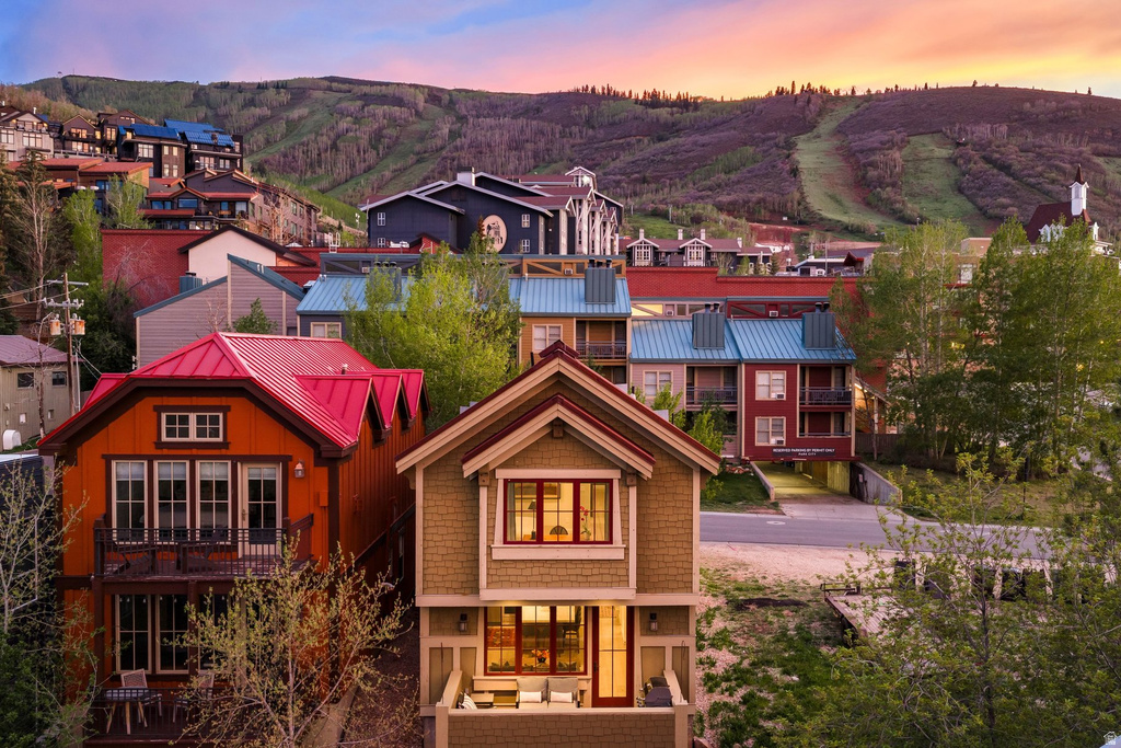 Two-story residence featuring a shingle exterior, a gabled roofline, and a private balcony