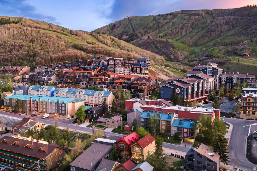 Mountain landscape featuring a collection of multi-story buildings with varied architectural styles, individual balconies, and distinct rooflines