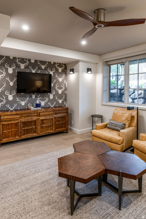 Living area featuring wood-finish flooring, recessed lighting, and a modern ceiling fan