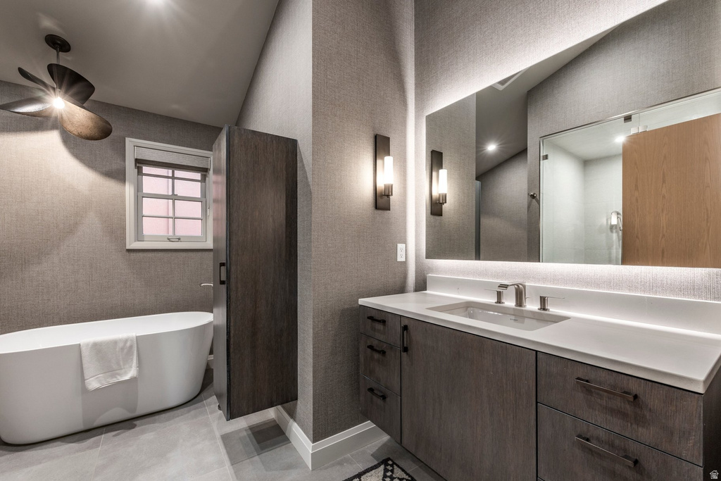 Contemporary bathroom featuring a freestanding soaking tub, a single window with blinds, and a dark wood-finish cabinet with a built-in vessel sink