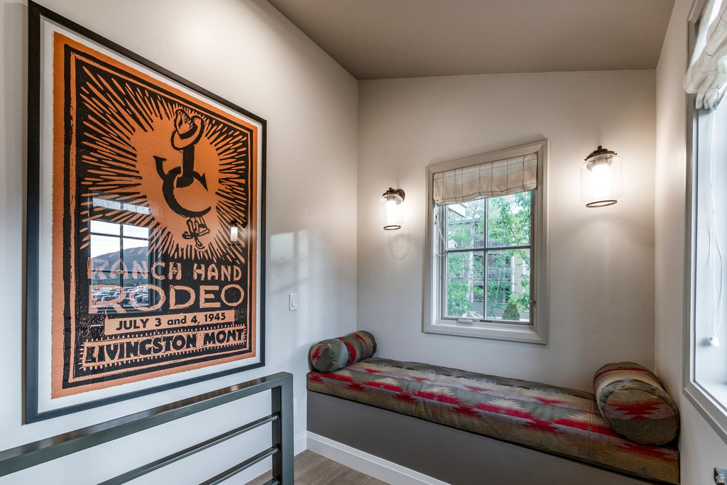 Integrated window seat with custom cushioning, flanked by two wall-mounted sconces