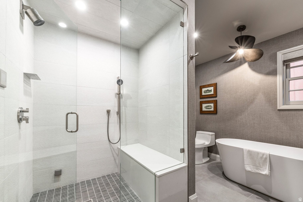 Spacious bathroom featuring a glass-enclosed shower with a built-in bench, ceiling-mounted showerhead, and handheld shower sprayer