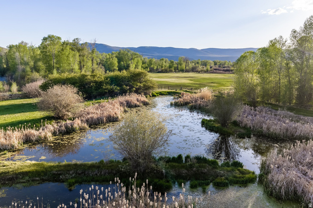 Natural water feature with surrounding wetlands and grassland