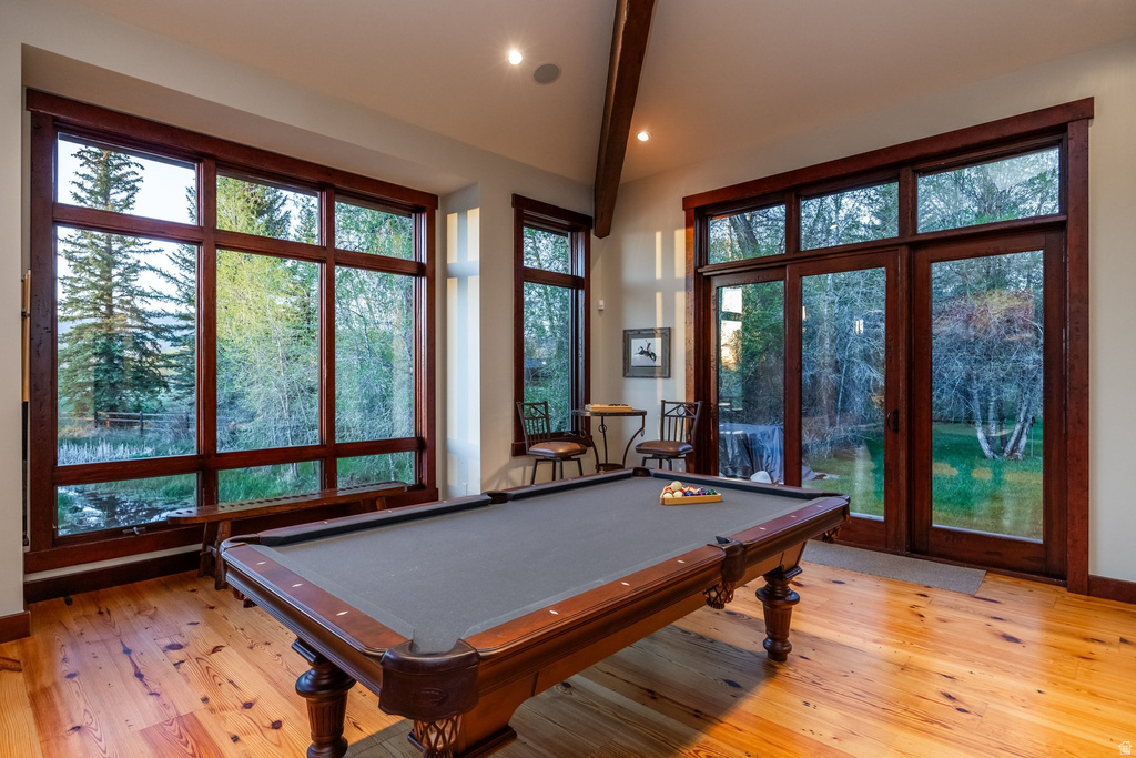 Spacious room featuring extensive wood-frame windows and a wood-frame glass door leading to the exterior