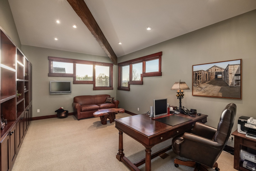 Spacious room featuring a vaulted ceiling with exposed wood beams, recessed lighting, and expansive built-in wood cabinetry