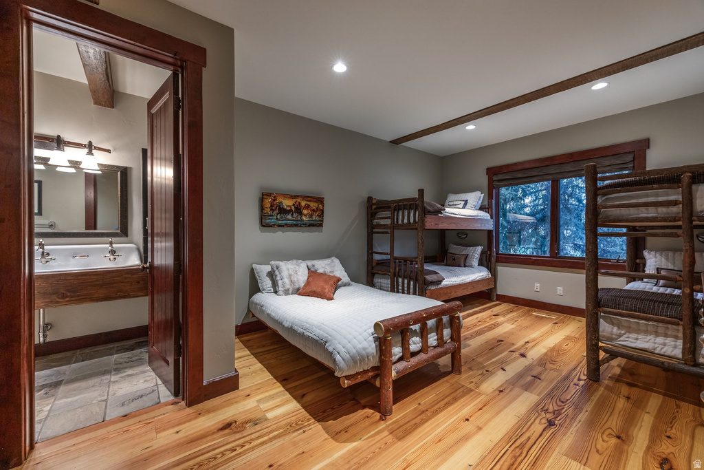 Hardwood flooring and exposed wood beams complement the room's aesthetic
