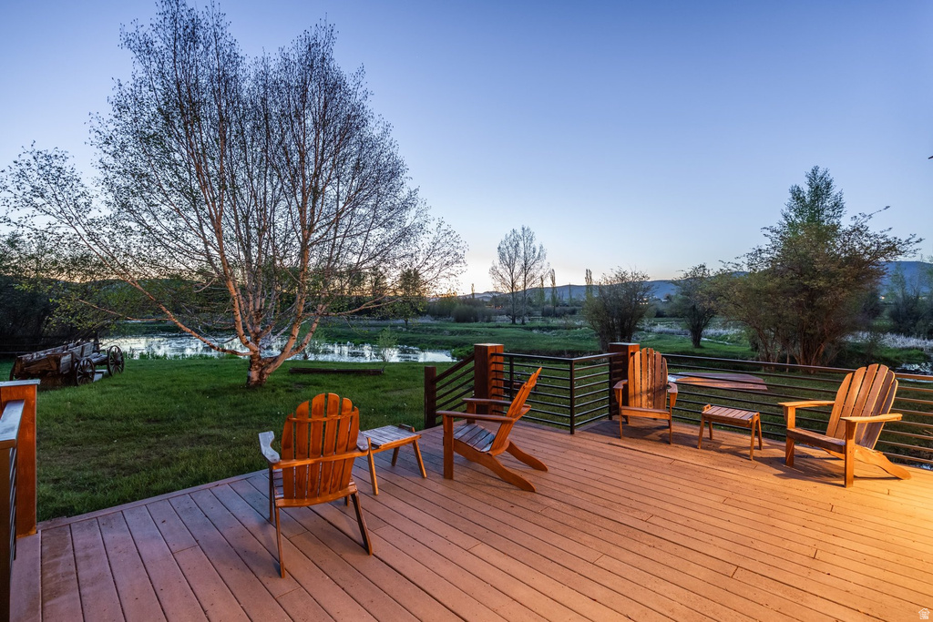 Spacious outdoor deck with composite decking, dark wood posts, and horizontal metal railing