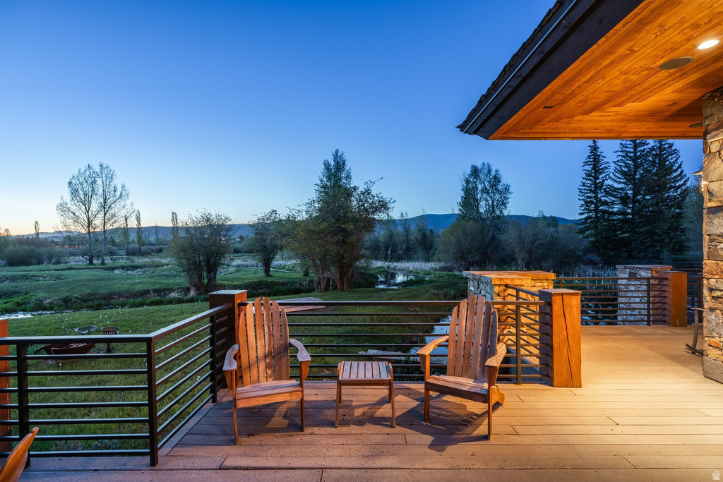 Expansive outdoor deck with composite decking, modern horizontal metal railings, and a wood-paneled soffit