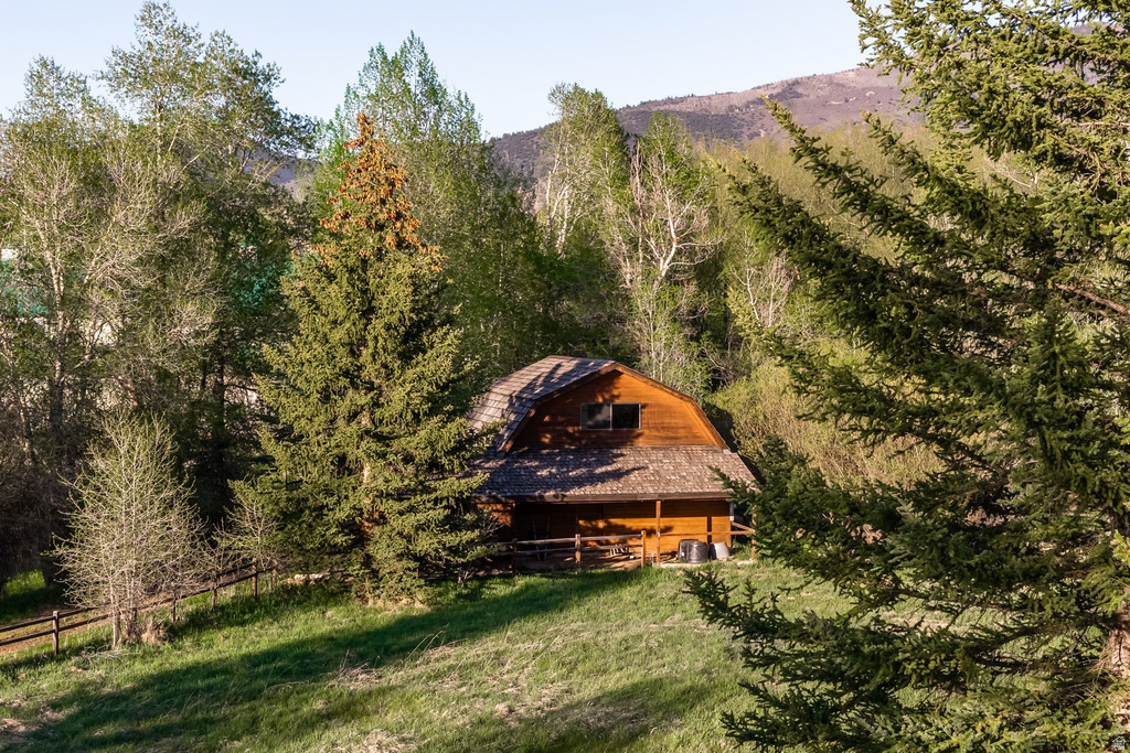 Wood-sided home featuring a prominent gabled roofline and covered porch