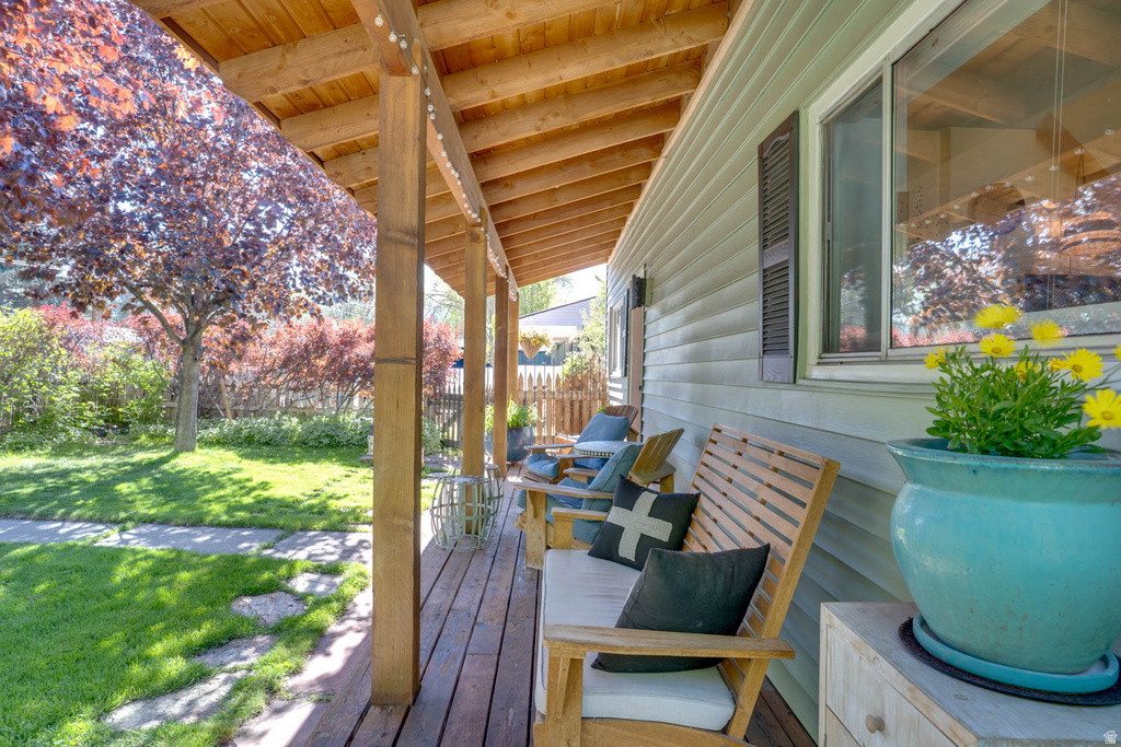 Inviting covered porch with natural wood posts and exposed beam ceiling