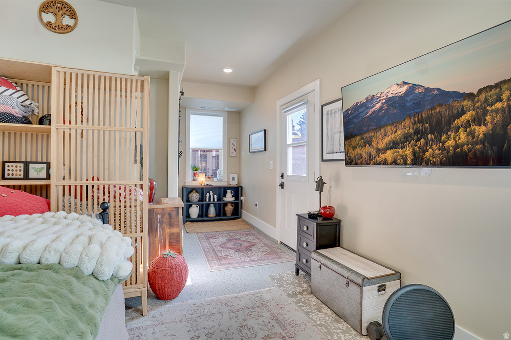 Cream-colored walls and light-toned flooring characterize this interior space, featuring a white door with dark hardware