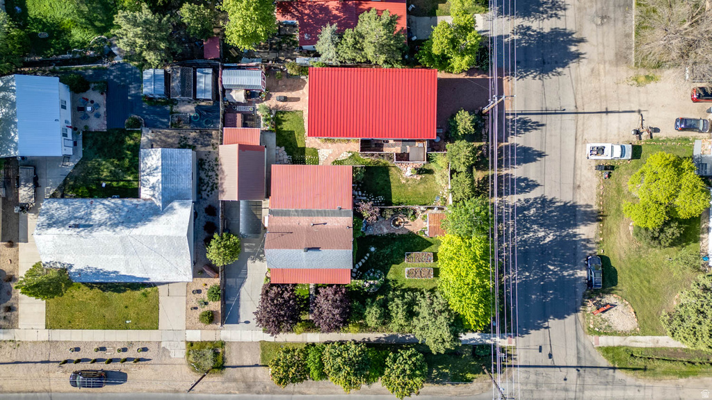 Aerial perspective showcasing multiple properties with distinctive red and silver metal roofs