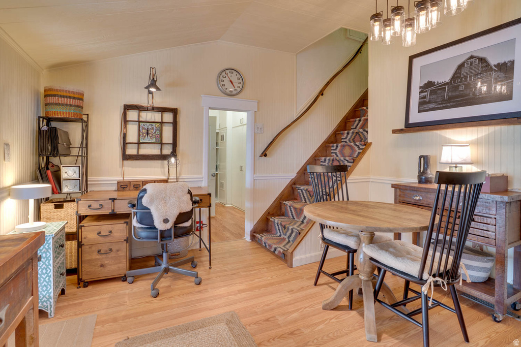 Light wood-finish flooring throughout, featuring a vaulted ceiling and beadboard wall paneling