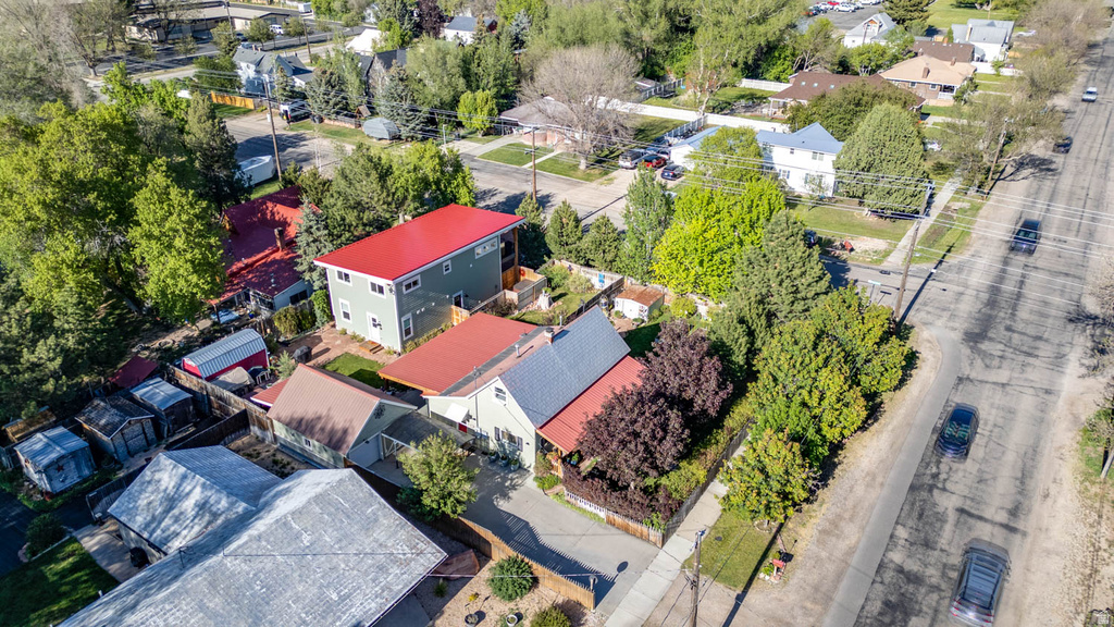 Aerial perspective showcasing multiple residential structures with red and gray roofing