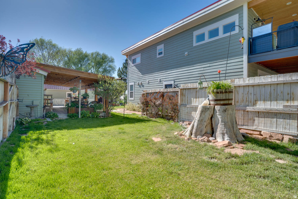 Expansive grassy lawn bordered by wood fencing