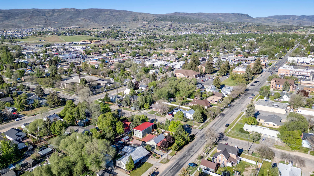 Aerial perspective showcasing a residential and commercial area with distant mountains