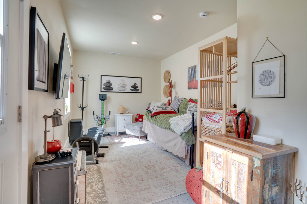 Versatile room featuring recessed lighting, a neutral color palette, and a patterned area rug