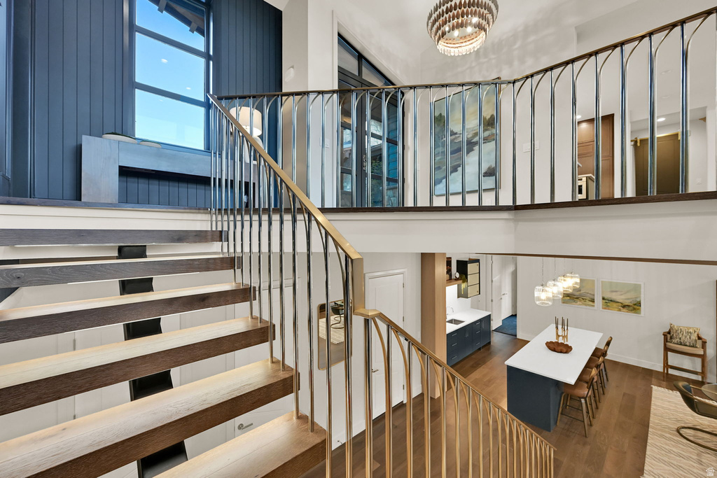 Open-riser staircase with wood-finish treads and metal railings