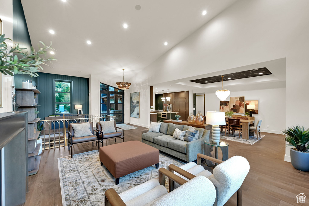Expansive open-concept living area featuring high vaulted ceilings, recessed lighting, and wood-finish flooring