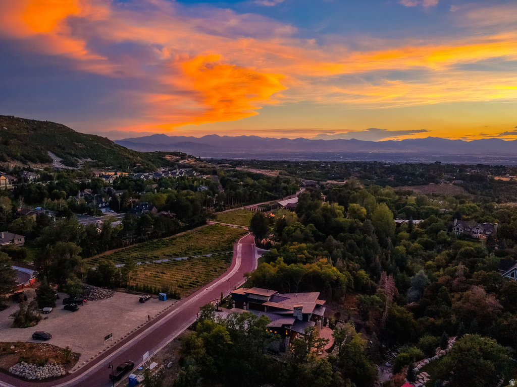 Aerial perspective showcasing a modern residence with a multi-level roofline and extensive outdoor patio space