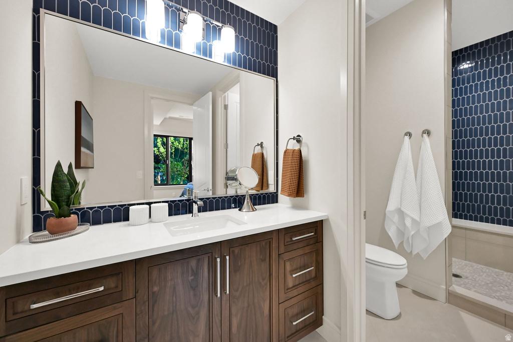 Contemporary bathroom vanity featuring a white countertop, undermount sink, and dark wood-finish cabinetry with silver hardware