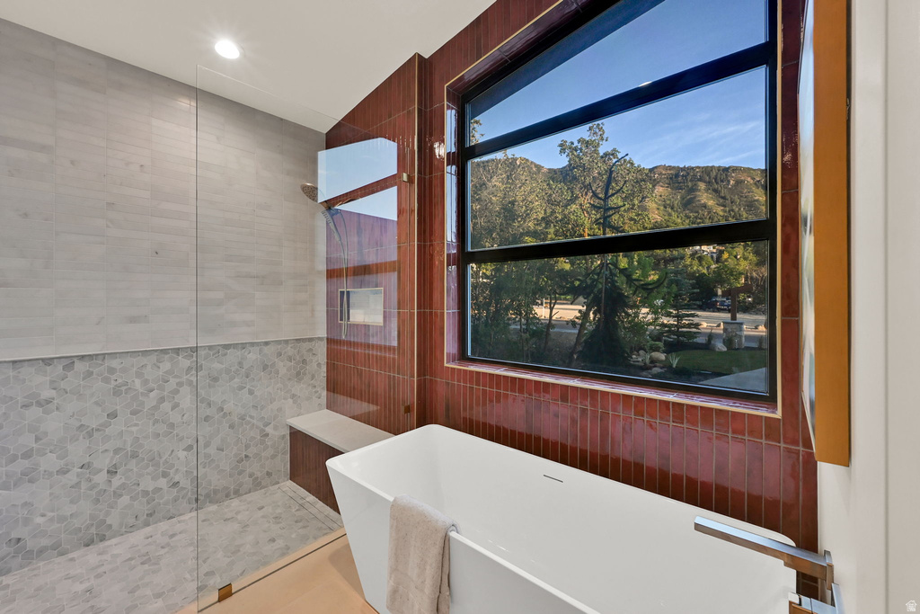 Freestanding soaking tub with a modern square profile and chrome fixtures