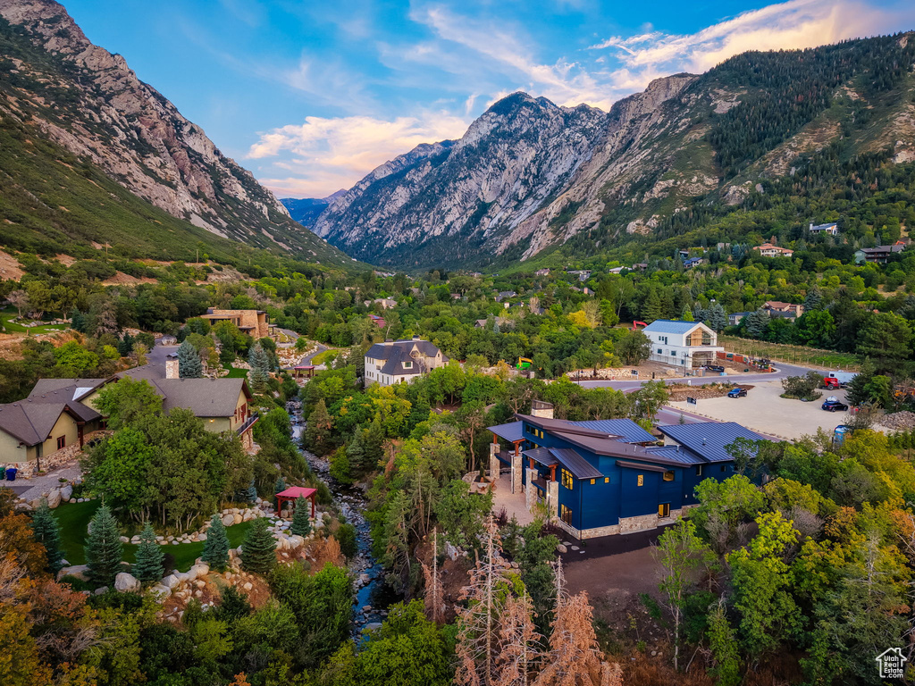 Modern architecture with blue siding and stone accents nestled in a mountainous landscape