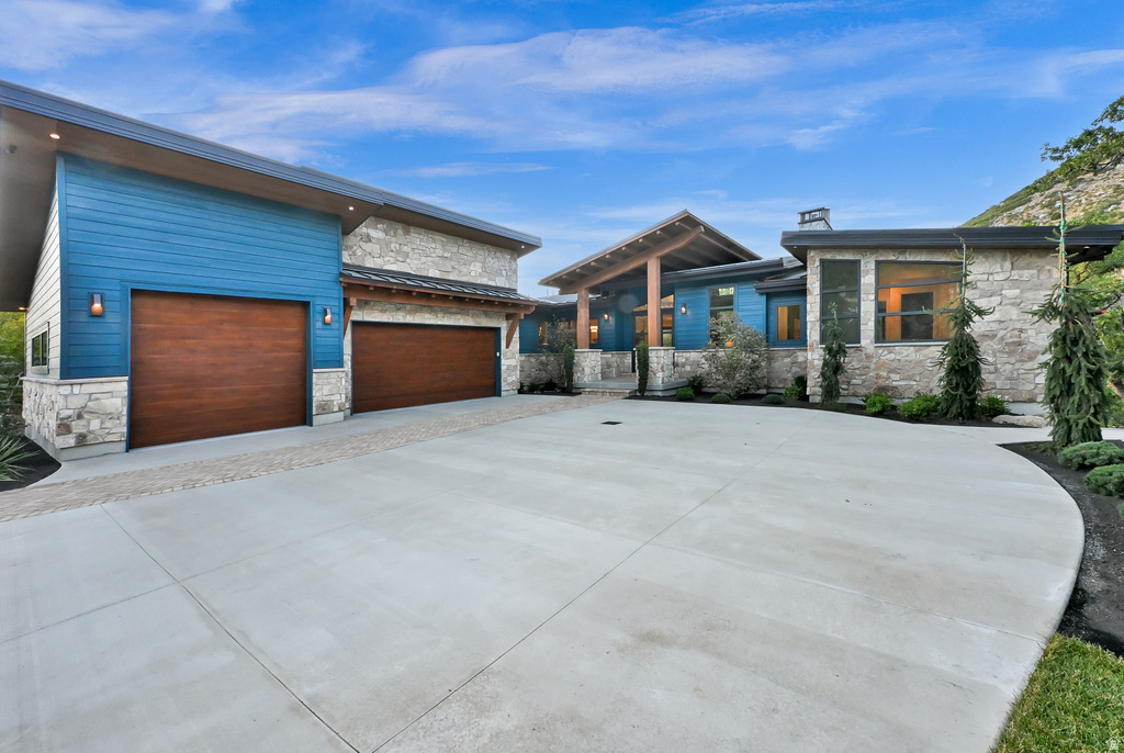 Contemporary exterior featuring stone accents and blue siding