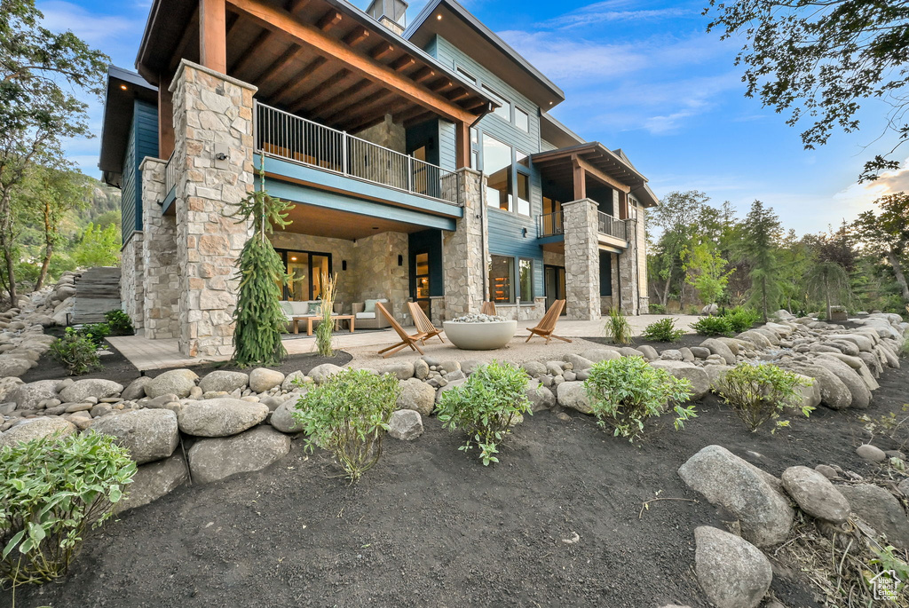 Stone and siding exterior with prominent wood beam accents