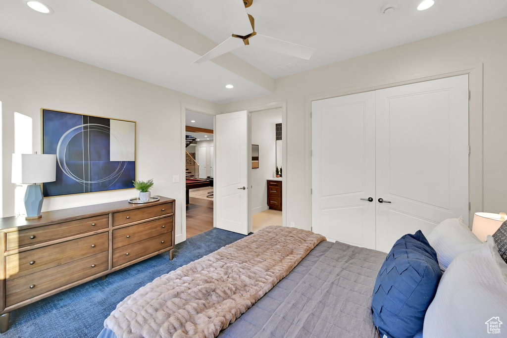 Recessed lighting illuminates this room, featuring a contemporary ceiling fan, white paneled doors, and light-toned walls