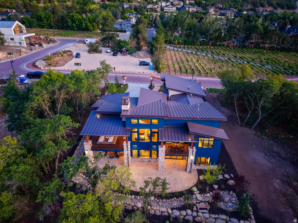 Contemporary residence featuring a blue exterior, multiple large windows, and a multi-level roofline