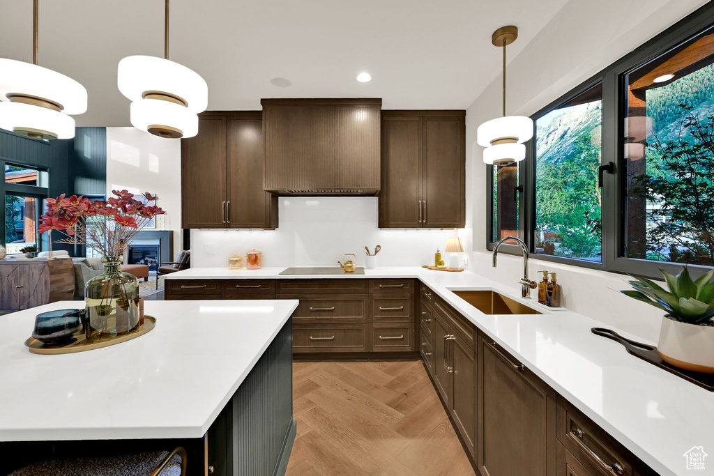 Modern kitchen featuring dark wood-finish cabinetry and white countertops