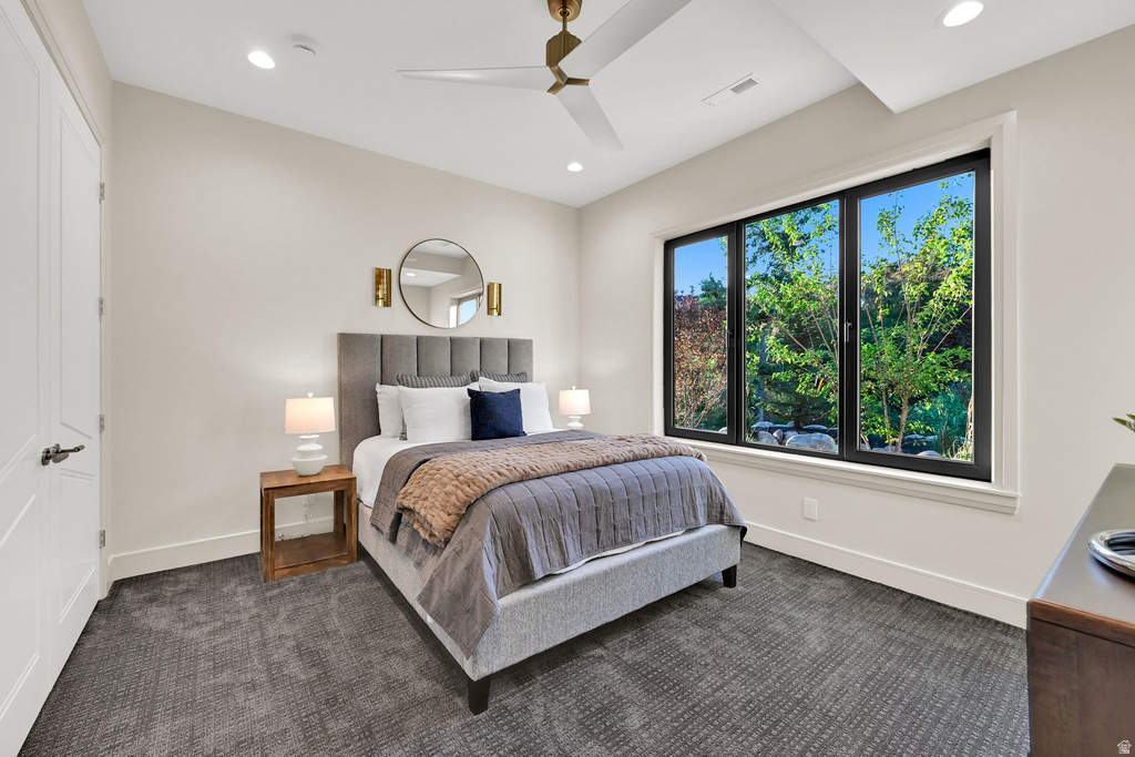 Large window with black framing, high ceilings, recessed lighting, and a contemporary ceiling fan